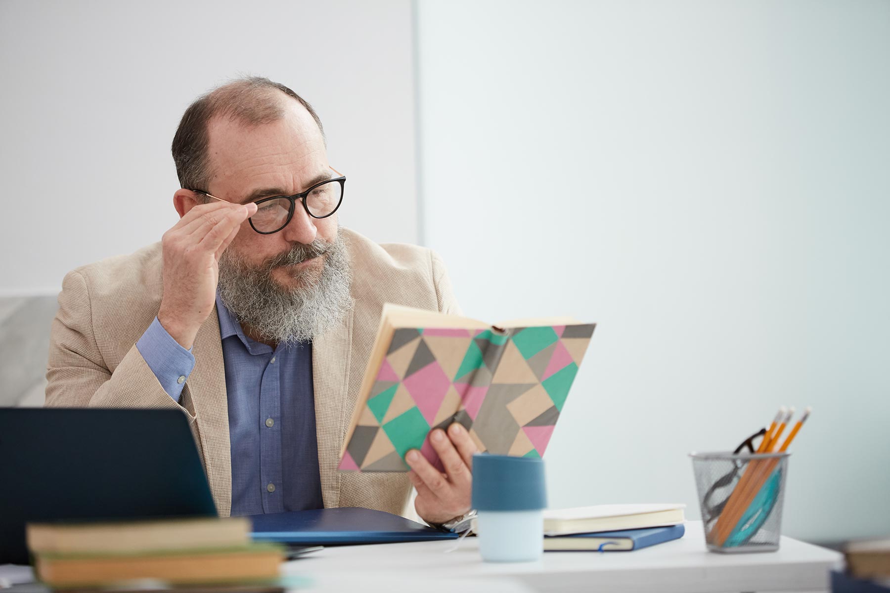 bearded senior teacher at desk CKRZKEN - Holy Comforter Episcopal Church & School