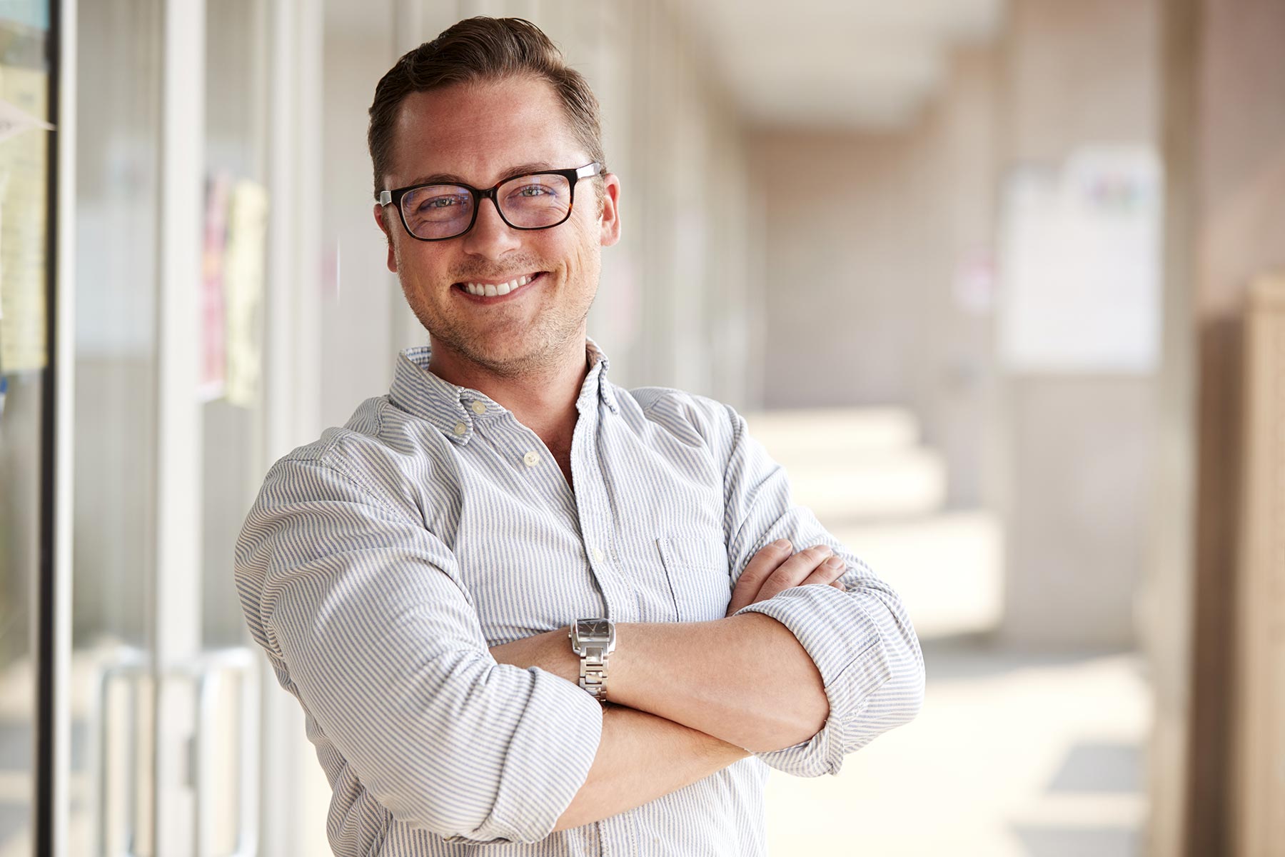 portrait of smiling male school teacher standing i 7KLZDMS - Holy Comforter Episcopal Church & School